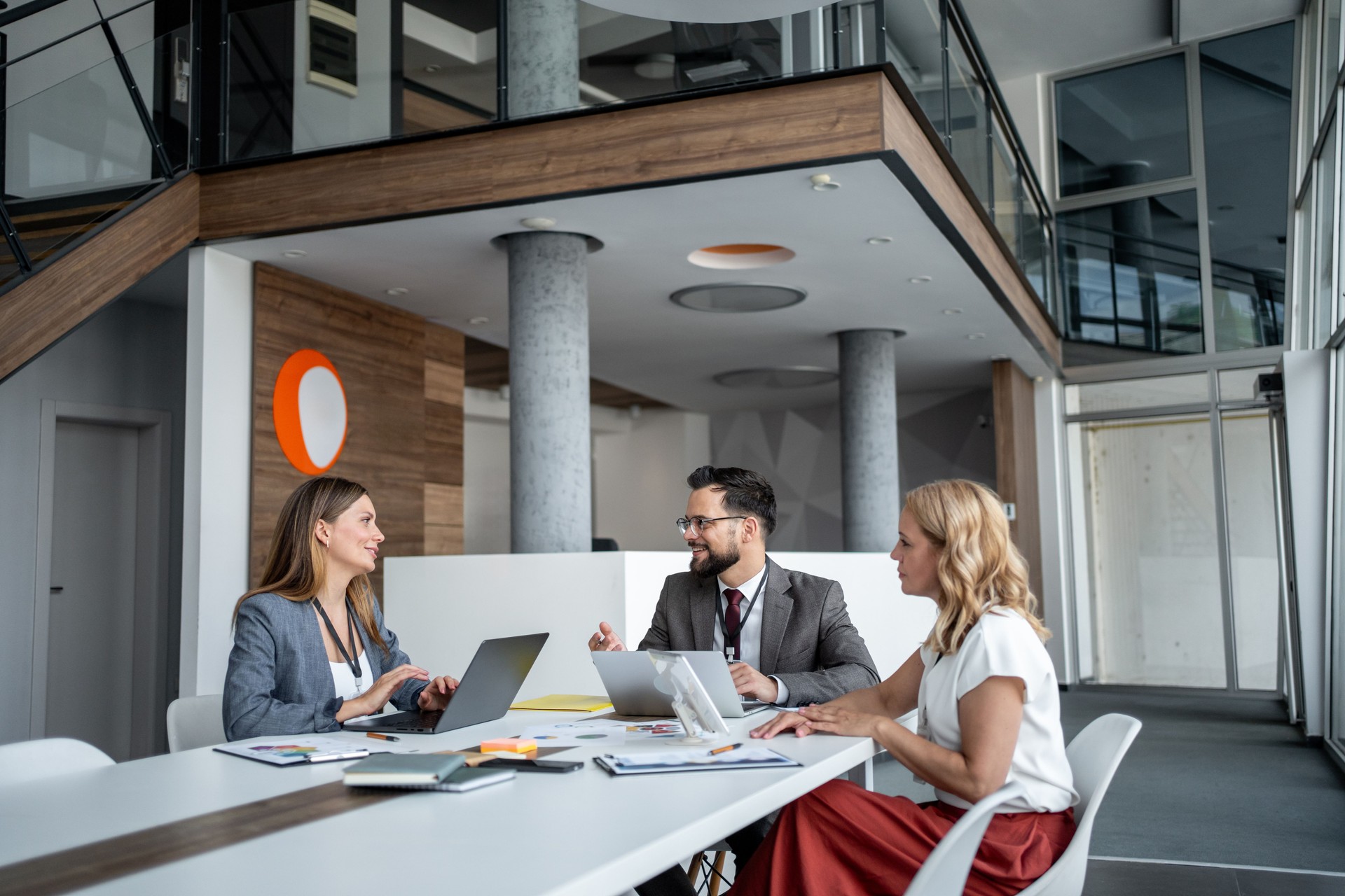 Business team having a meeting using laptops in modern office
