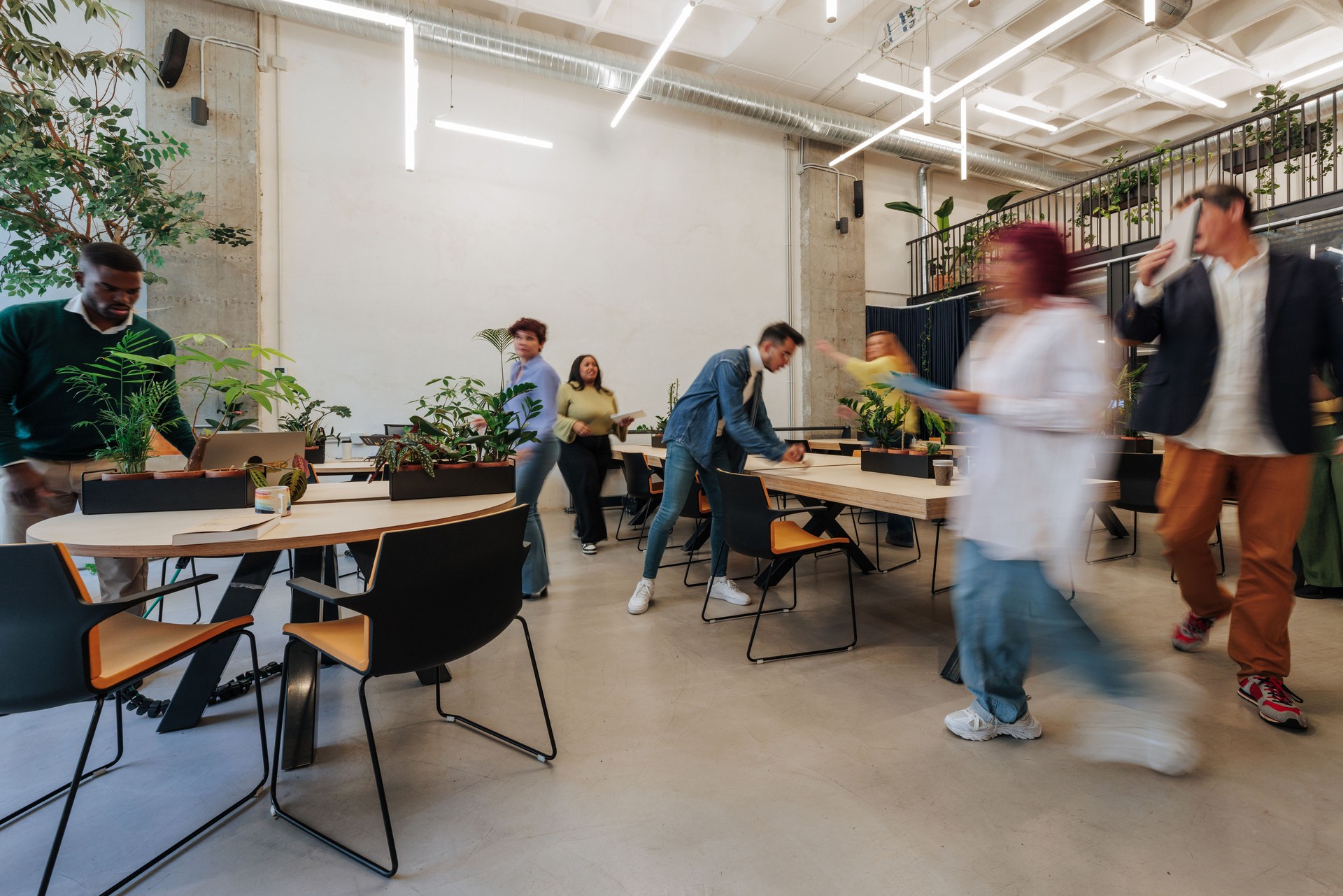 Busy multicultural businesspeople working in a modern green office
